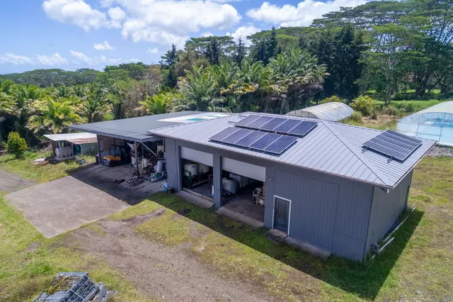 an aerial view of a house with garden space and street view