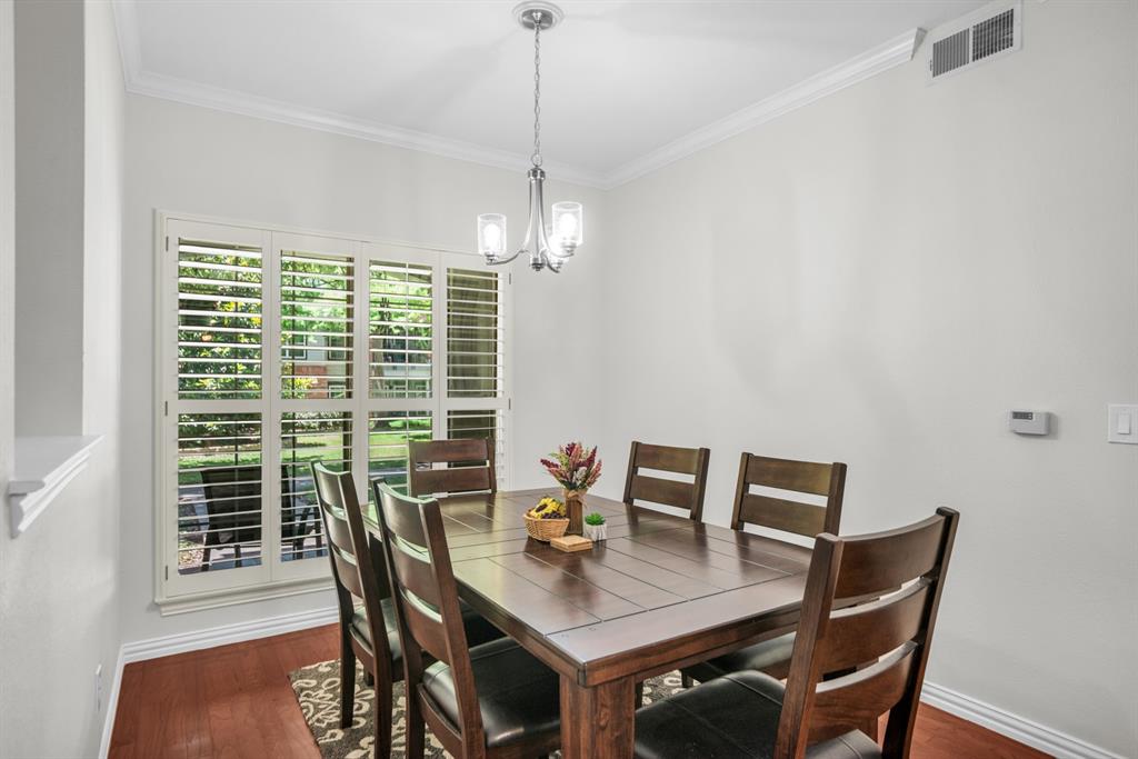 2524 Preston Road, Unit 808 Plano, TX 75093 - Photo 17 of 31 Dining area featuring wood flooring, white plantation shutters, and a contemporary chandelier