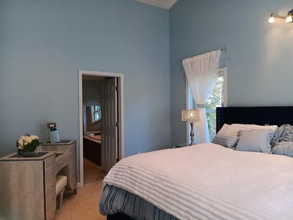 a bedroom with a bed and a chandelier