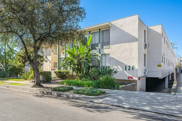 a view of a house with a swimming pool and a yard