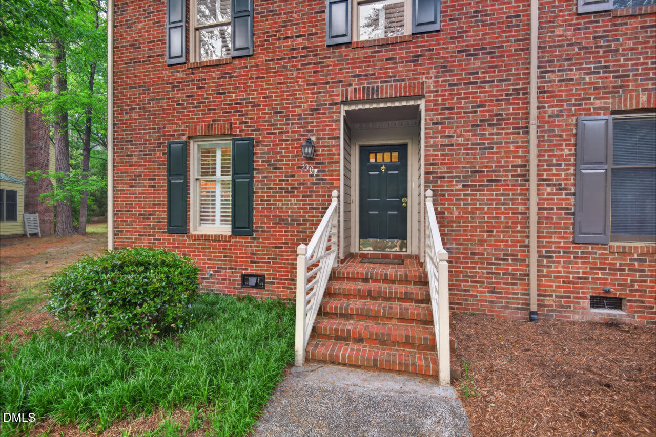 3307 Coachman's Way Durham, NC 27705 - Photo 2 of 50 a view of a brick house with wooden fence