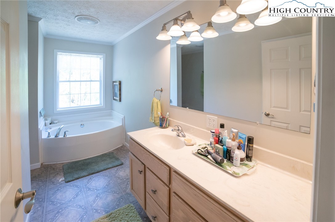 182 Henley Lane Newland, NC 28657 - Photo 17 of 28 a bathroom with a tub sink and mirror