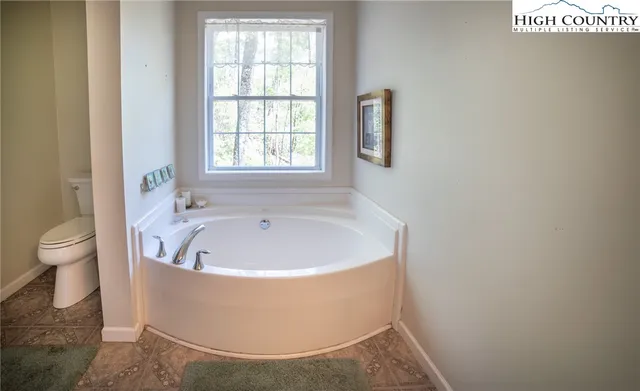 a white bath tub sitting next to a toilet