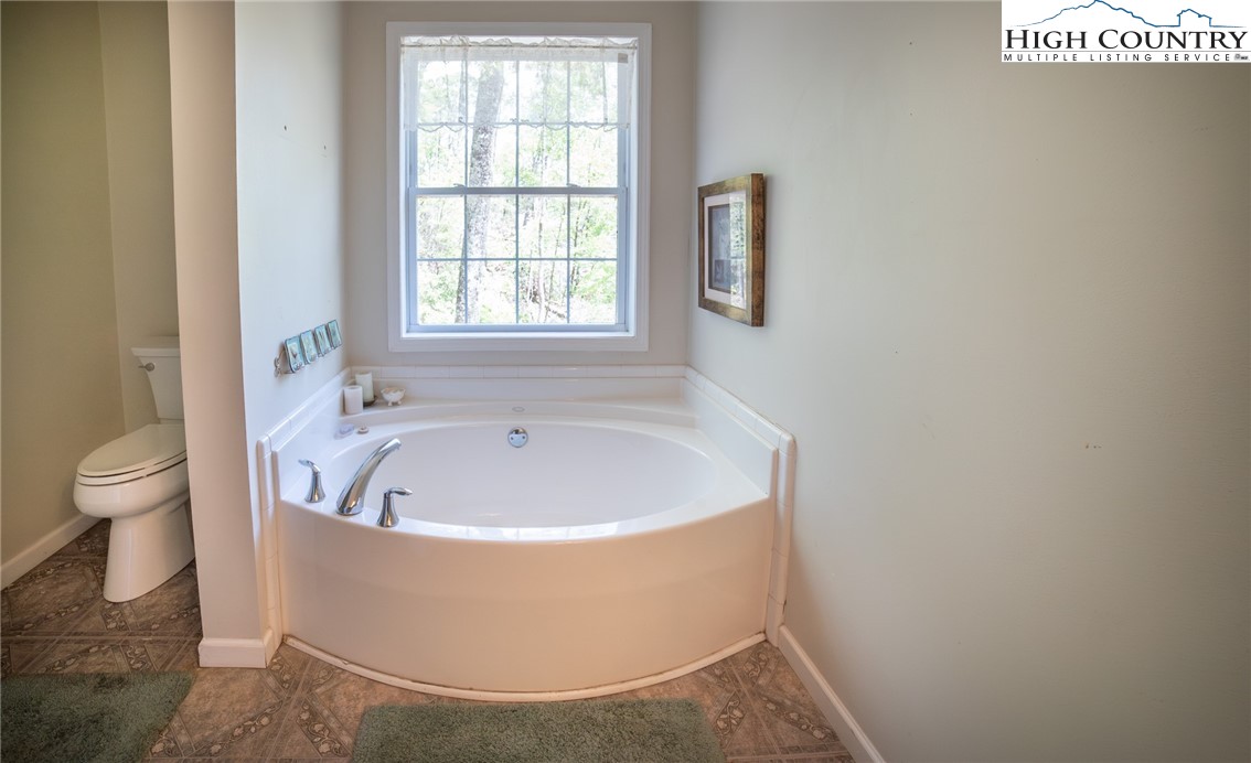 182 Henley Lane Newland, NC 28657 - Photo 18 of 28 a white bath tub sitting next to a toilet
