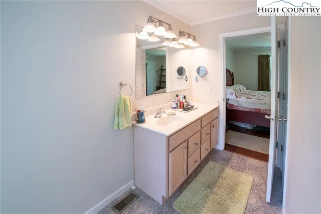a bathroom with a sink vanity and mirror