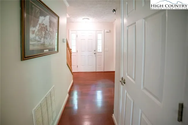 a view of hallway with wooden floor