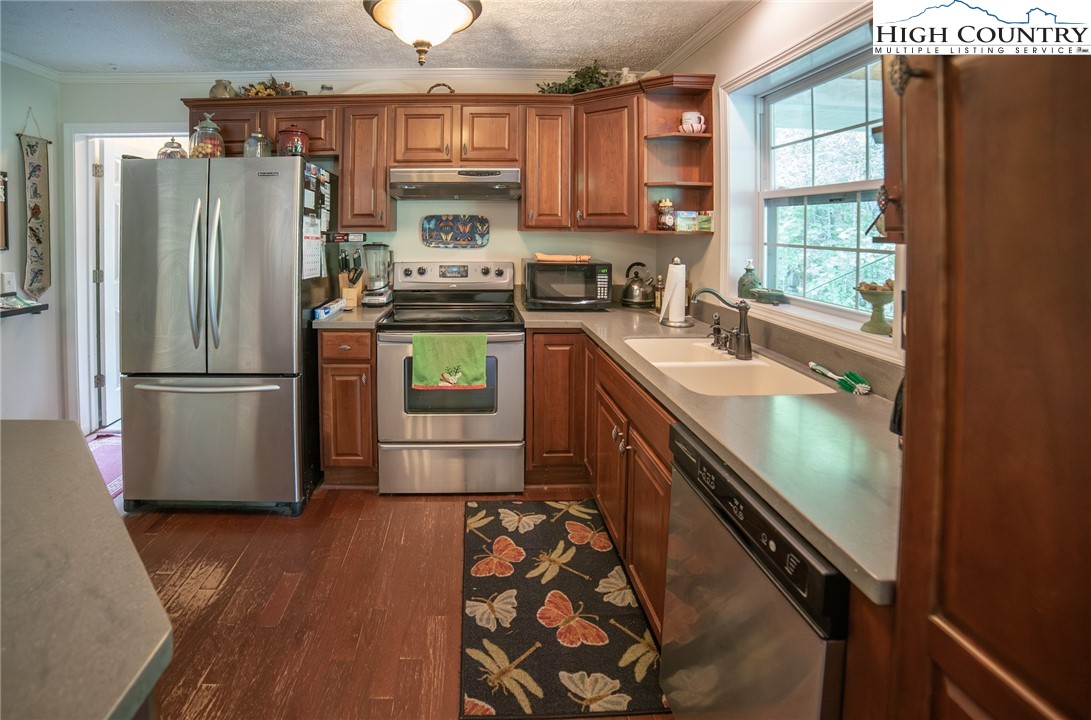 182 Henley Lane Newland, NC 28657 - Photo 5 of 28 a kitchen with stainless steel appliances granite countertop a refrigerator a sink and a stove