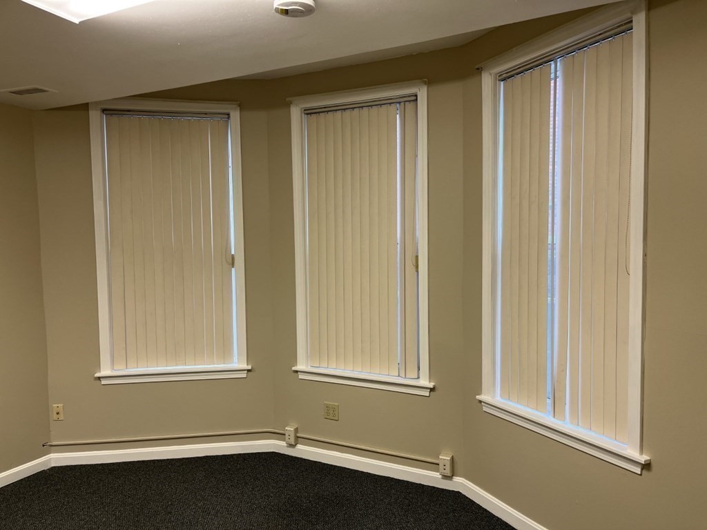 5 State Street, Unit R1 Worcester, MA 01609 - Photo 24 of 26 a view of an empty room with a window and wooden floor