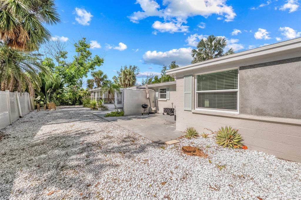 578 Companion Way Longboat Key, FL 34228 - Photo 15 of 70 a backyard of a house with lots of green space and outdoor seating