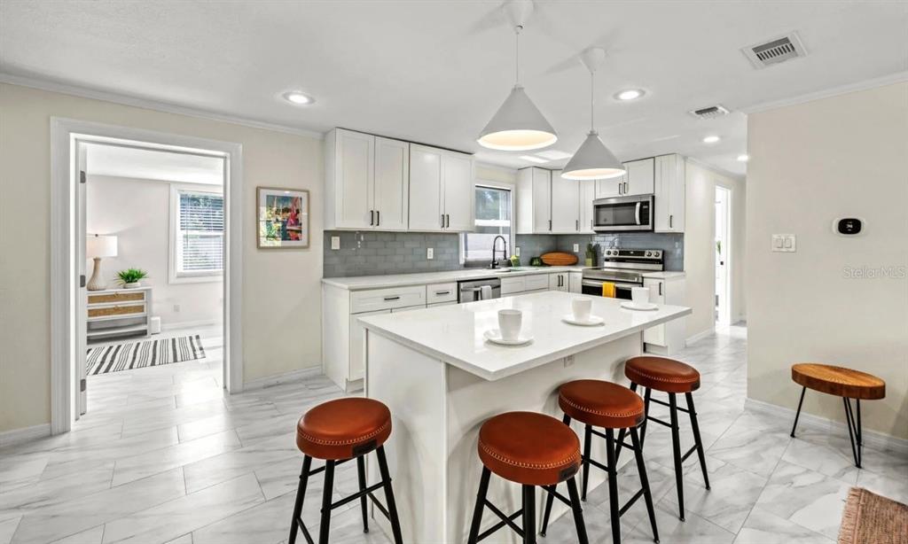 578 Companion Way Longboat Key, FL 34228 - Photo 24 of 70 a kitchen with stainless steel appliances a stove a sink and a refrigerator