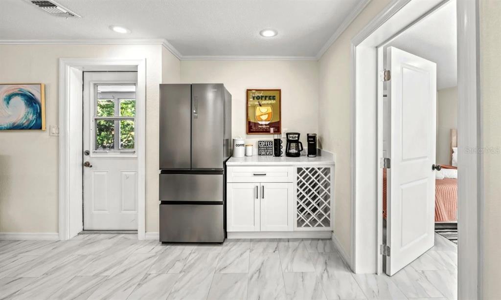 578 Companion Way Longboat Key, FL 34228 - Photo 28 of 70 a kitchen with white cabinets and wooden floor