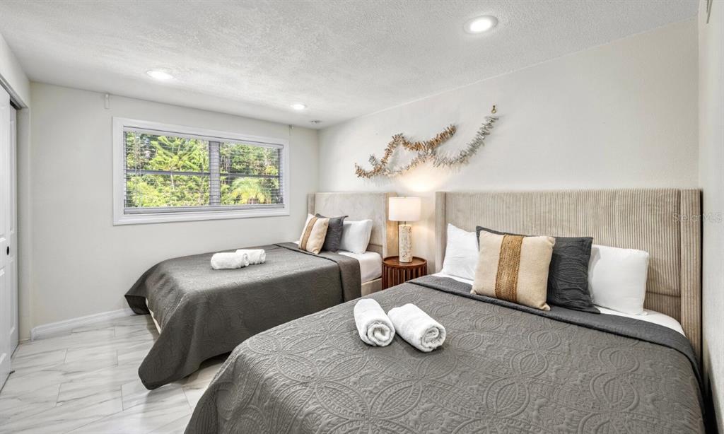 578 Companion Way Longboat Key, FL 34228 - Photo 31 of 70 a bedroom with two beds and a large window