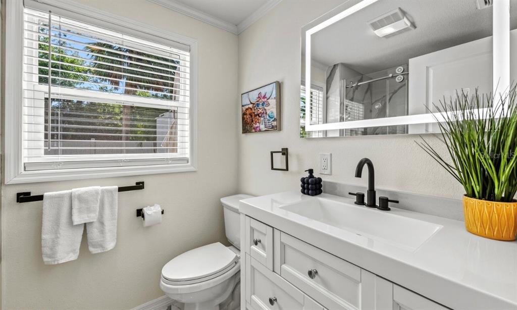 578 Companion Way Longboat Key, FL 34228 - Photo 33 of 70 a bathroom with a sink a toilet and a mirror