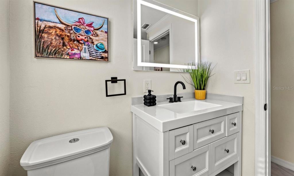 578 Companion Way Longboat Key, FL 34228 - Photo 34 of 70 a bathroom with a sink a vanity and a mirror