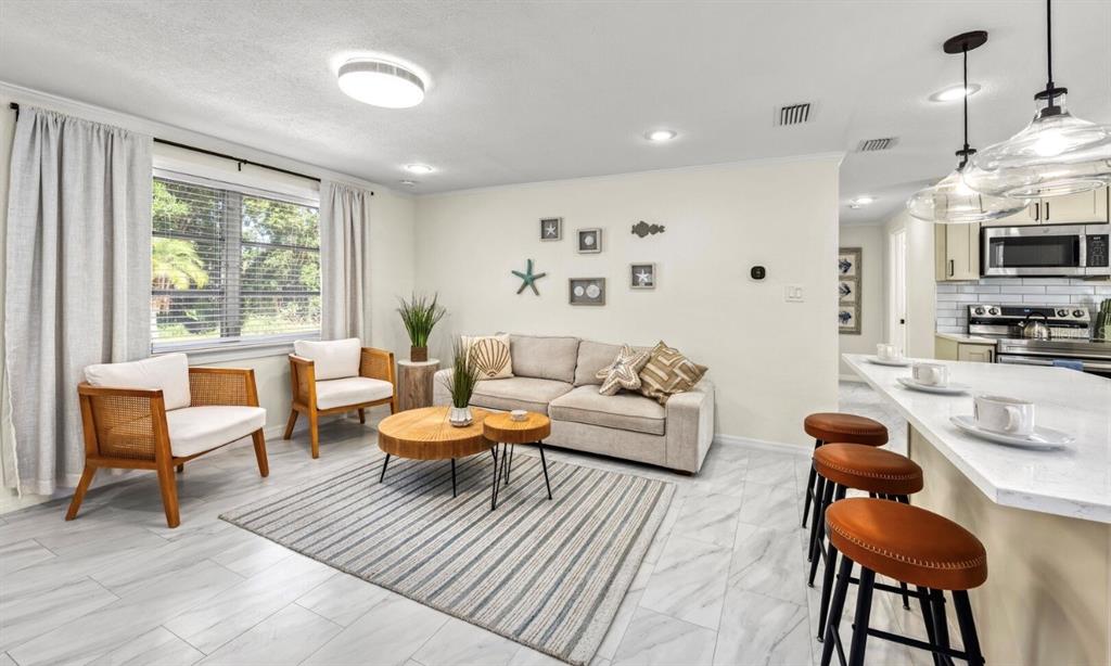 578 Companion Way Longboat Key, FL 34228 - Photo 47 of 70 a living room with furniture a rug and a large window
