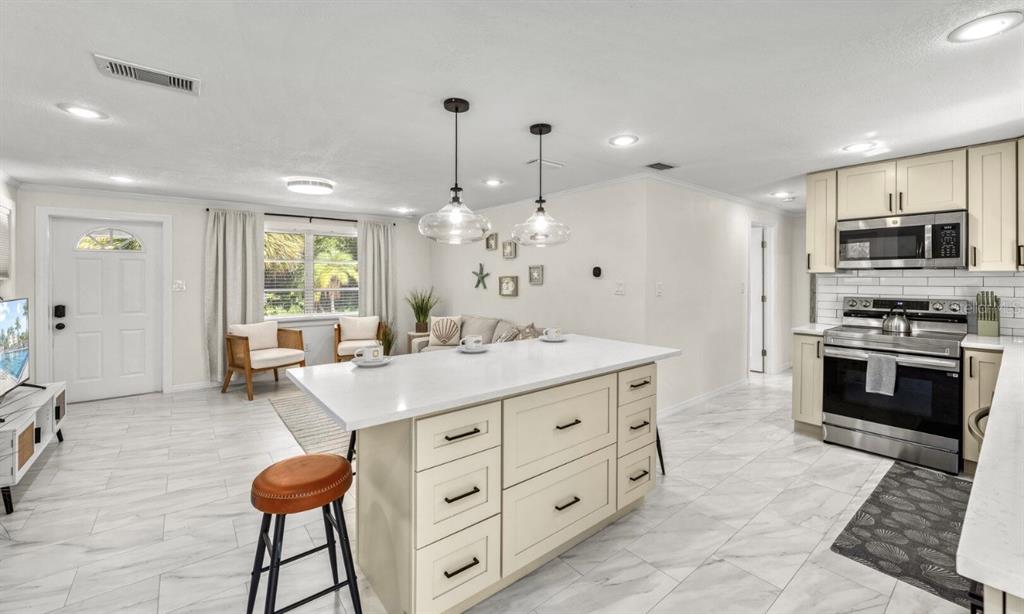 578 Companion Way Longboat Key, FL 34228 - Photo 51 of 70 a kitchen with granite countertop a stove a sink and a refrigerator