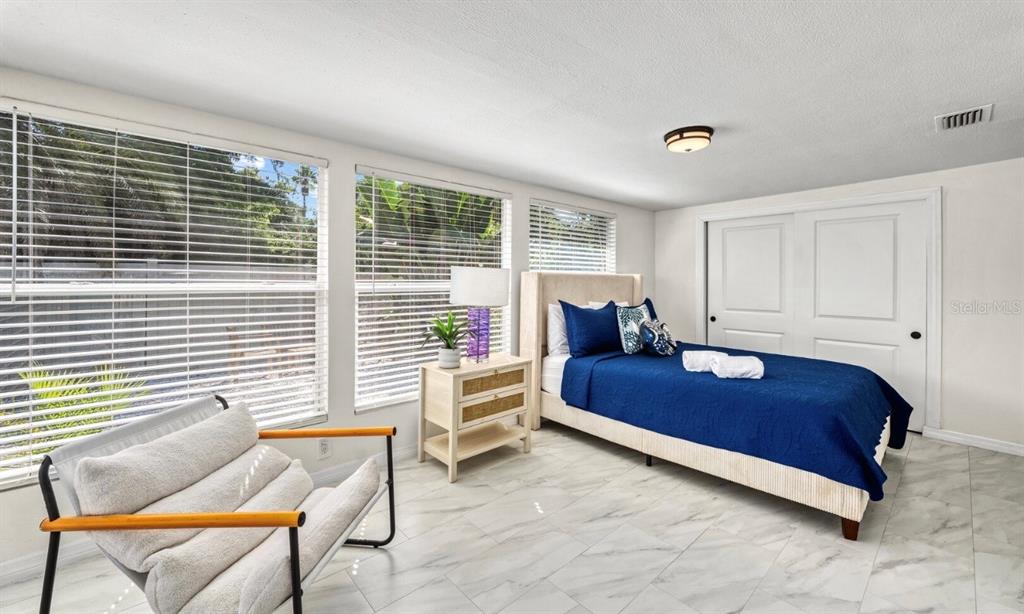 578 Companion Way Longboat Key, FL 34228 - Photo 55 of 70 a bedroom with a bed and chair