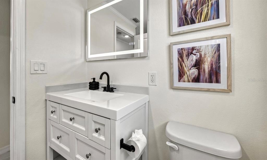 578 Companion Way Longboat Key, FL 34228 - Photo 57 of 70 a bathroom with a toilet a sink and mirror