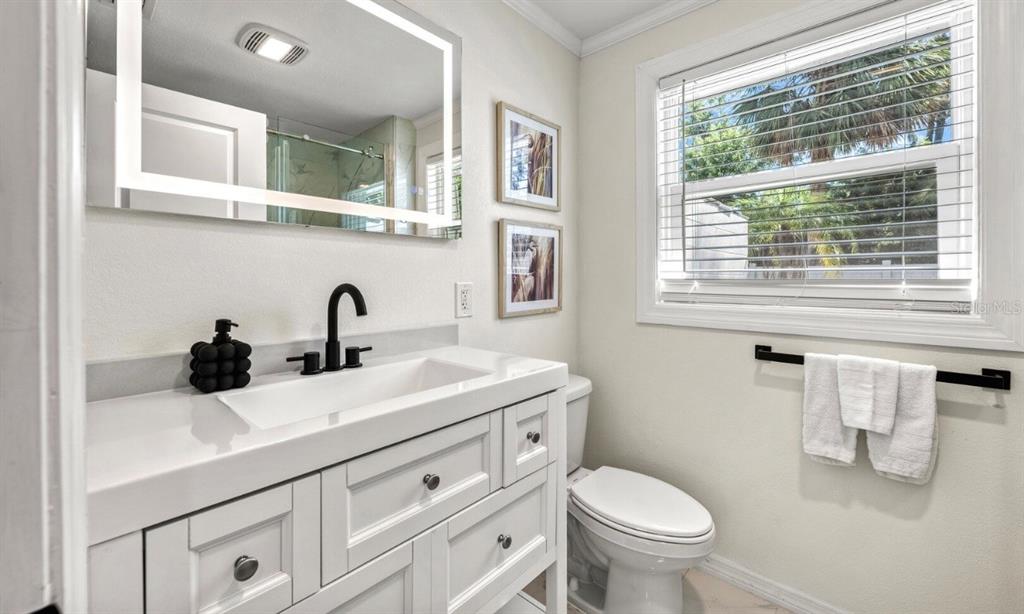 578 Companion Way Longboat Key, FL 34228 - Photo 58 of 70 a bathroom with a toilet a sink and a window