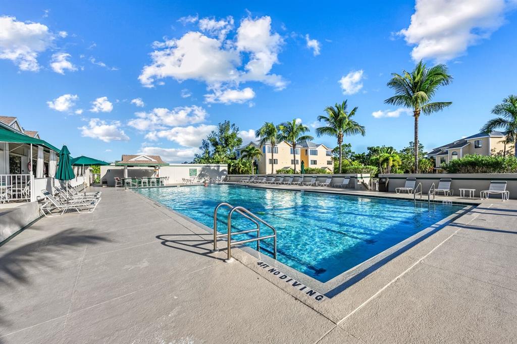 578 Companion Way Longboat Key, FL 34228 - Photo 69 of 70 a view of a swimming pool with a lounge chairs and a yard