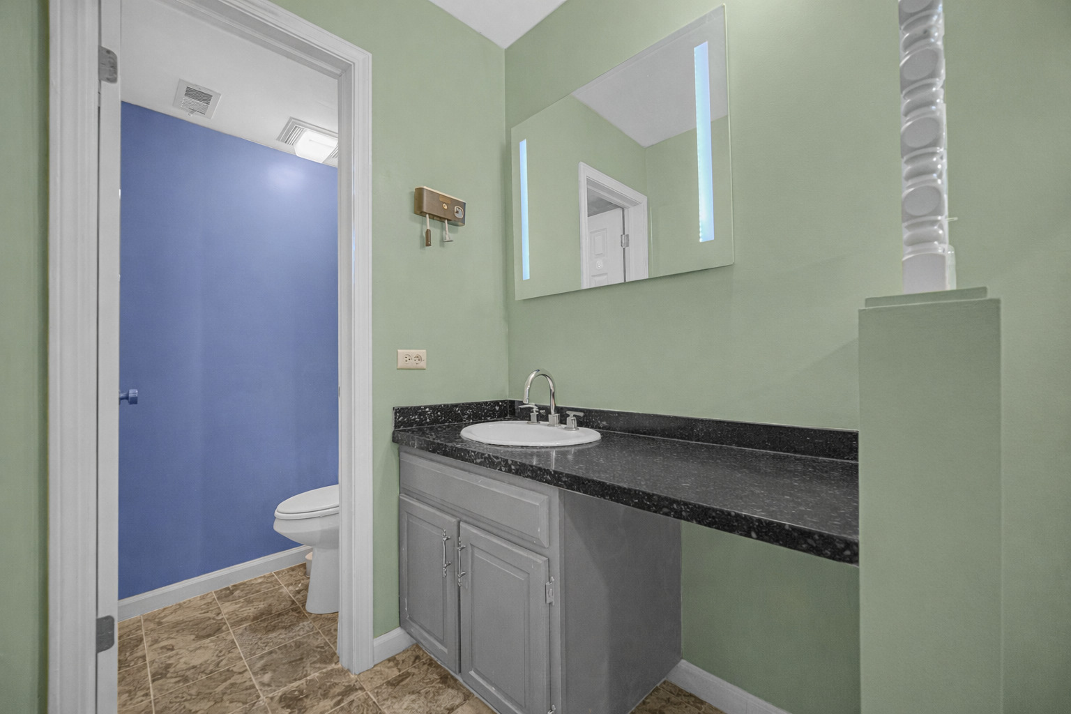 18559 Escanaba Avenue, Unit 201 Lansing, IL 60438 - Photo 12 of 17 a bathroom with a granite countertop sink and a mirror