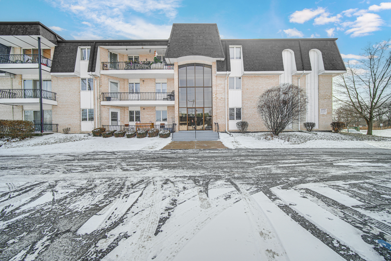 18559 Escanaba Avenue, Unit 201 Lansing, IL 60438 - Photo 16 of 17 a front view of a building with a ocean view