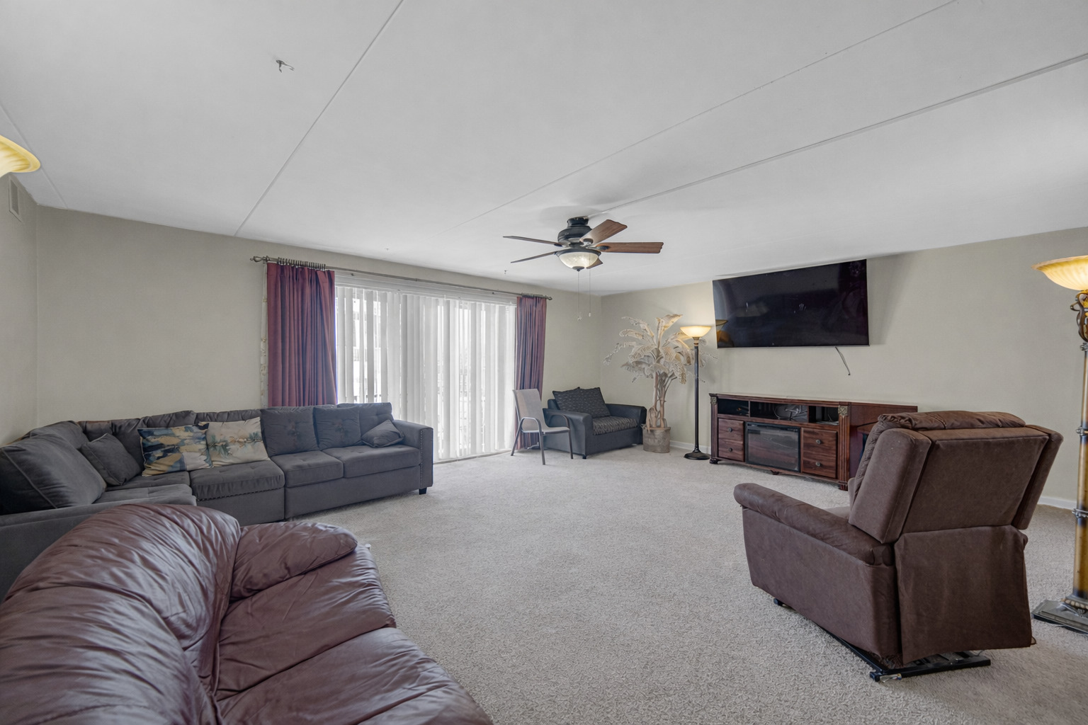 18559 Escanaba Avenue, Unit 201 Lansing, IL 60438 - Photo 4 of 17 a living room with furniture and a flat screen tv