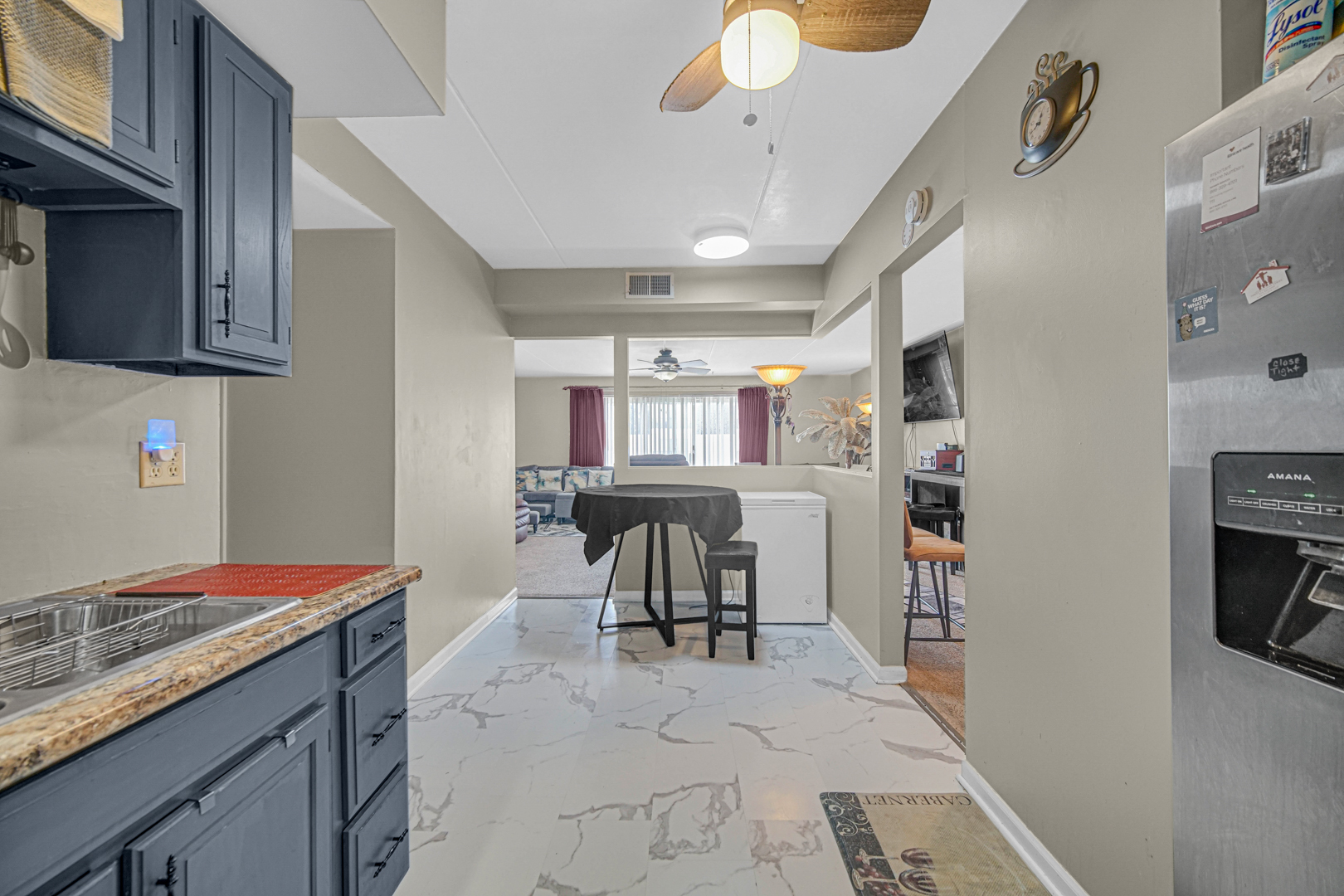 18559 Escanaba Avenue, Unit 201 Lansing, IL 60438 - Photo 6 of 17 a kitchen with stainless steel appliances kitchen island granite countertop a sink and cabinets