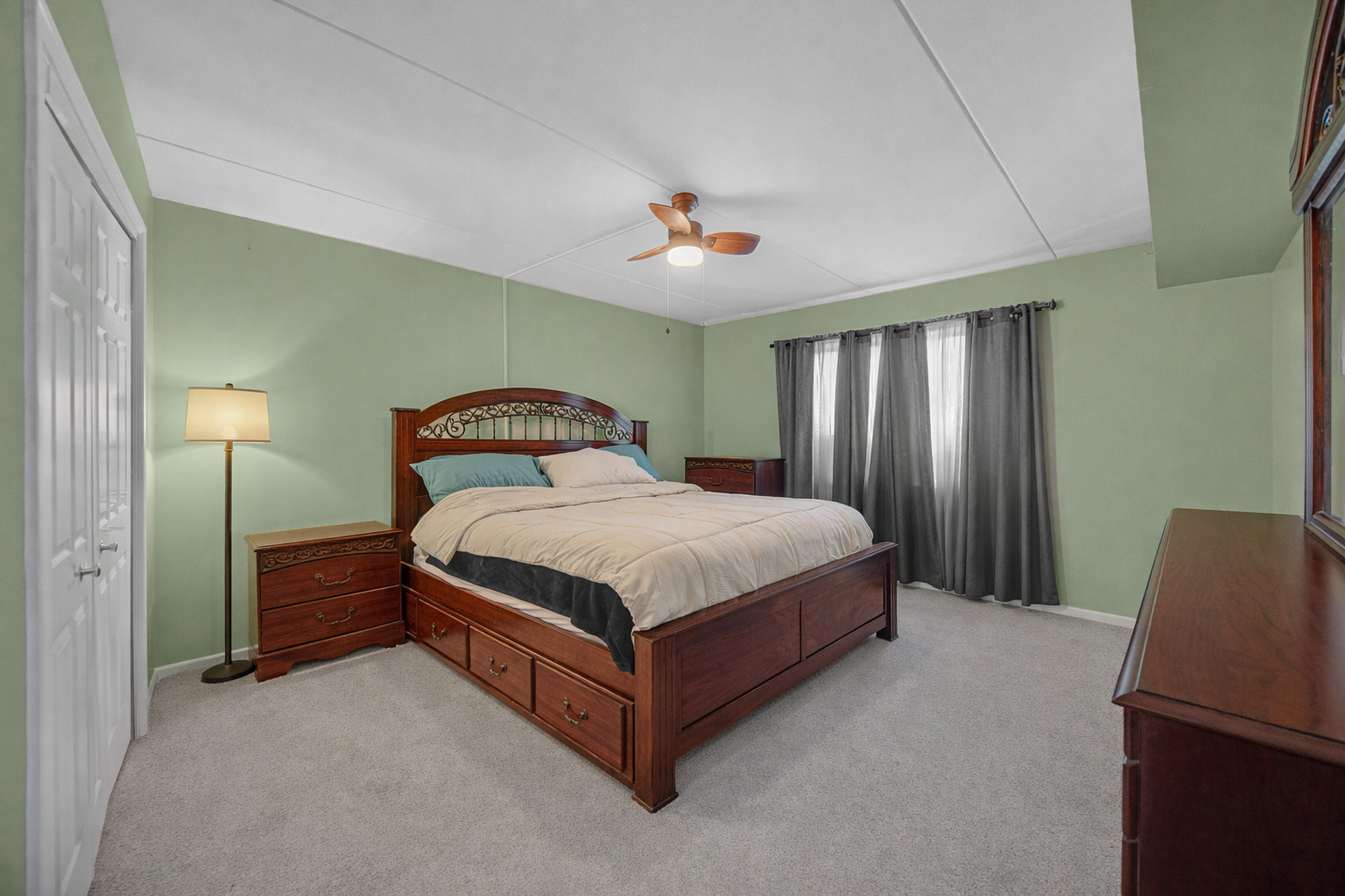 18559 Escanaba Avenue, Unit 201 Lansing, IL 60438 - Photo 9 of 17 a spacious bedroom with a bed and a chandelier