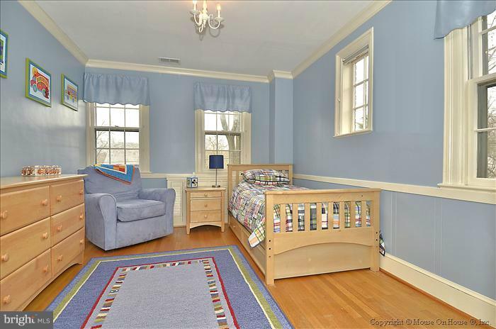 9423 Thornhill Road Silver Spring, MD 20901 - Photo 20 of 30 a spacious bedroom with a bed and a couch