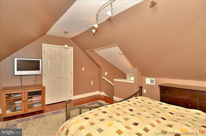 9423 Thornhill Road Silver Spring, MD 20901 - Photo 21 of 30 a bedroom with a bed and a flat screen tv