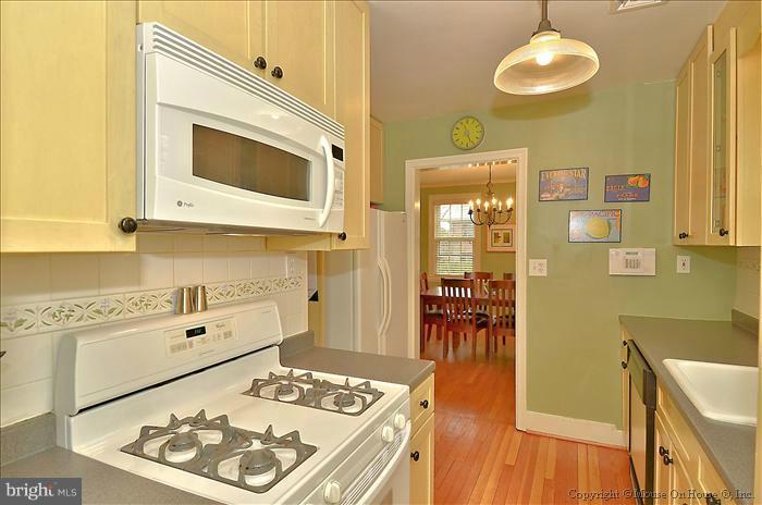 9423 Thornhill Road Silver Spring, MD 20901 - Photo 6 of 30 a kitchen with stainless steel appliances granite countertop a stove a microwave and a dining table