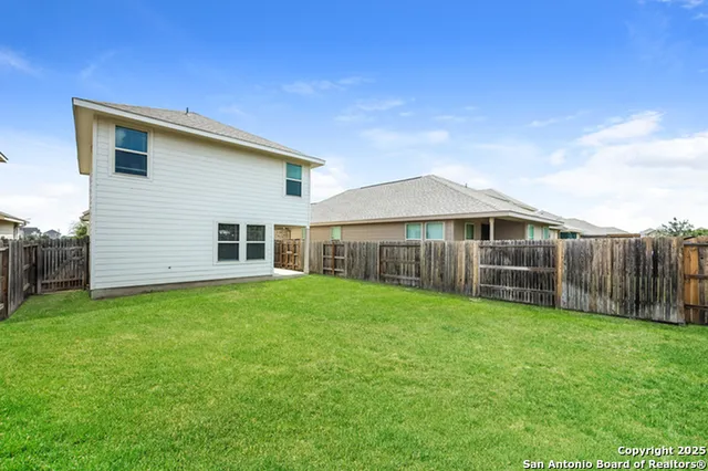 a view of a house with a yard and porch