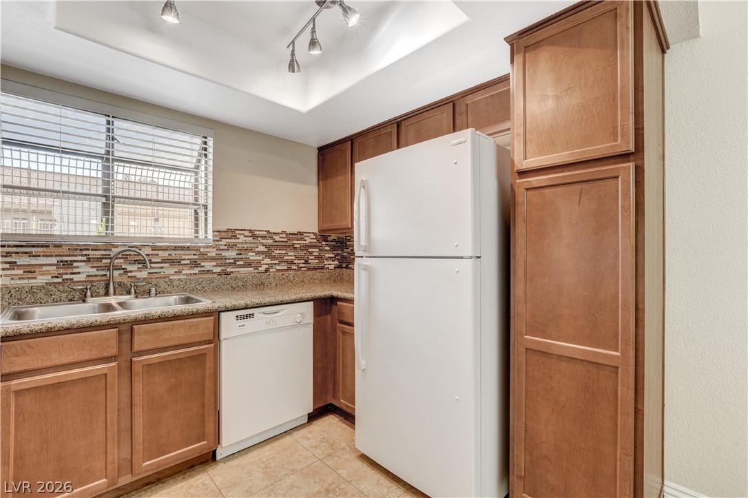 7200 West Pirates Cove Road, Unit 1026 Las Vegas, NV 89145 - Photo 14 of 35 This functional kitchen features ample cabinetry and integrated appliances for comfortable living.