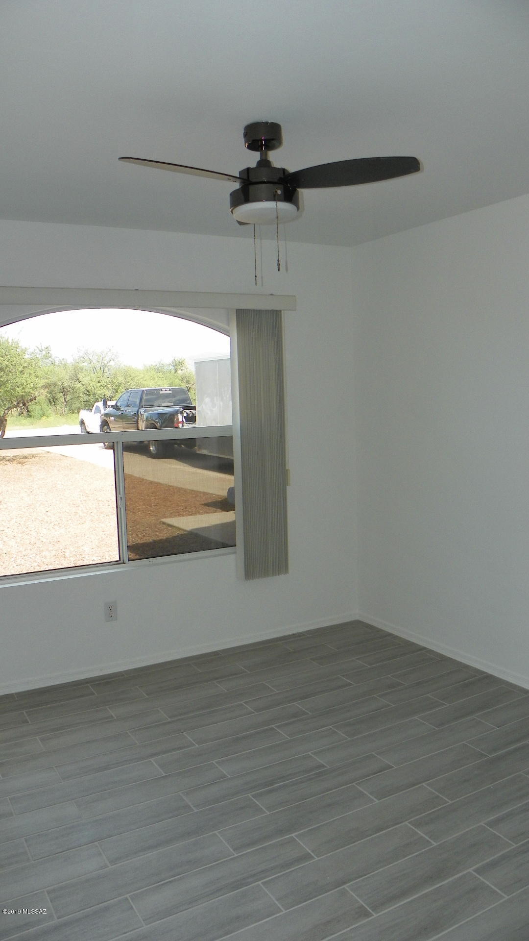 1731 Círculo Alameda Rio Rico, AZ 85648 - Photo 17 of 33 a view of a room with wooden floor and windows