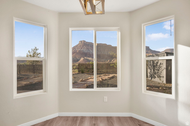 1440 West 100 South Virgin, UT 84779 - Photo 16 of 45 Bay window area featuring three expansive windows, wood-finish flooring, white baseboards, and a contemporary ceiling light fixture