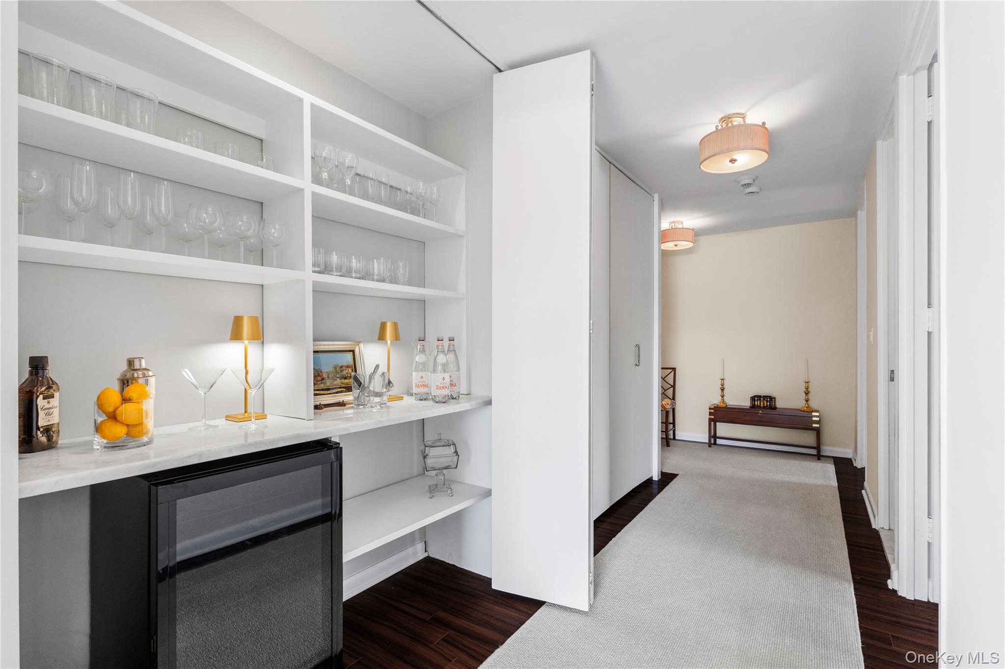 720 Milton Road, Unit SOUTH 3B Rye, NY 10580 - Photo 18 of 33 Featuring a marble counter, built in shelving and a wine refrigerator.