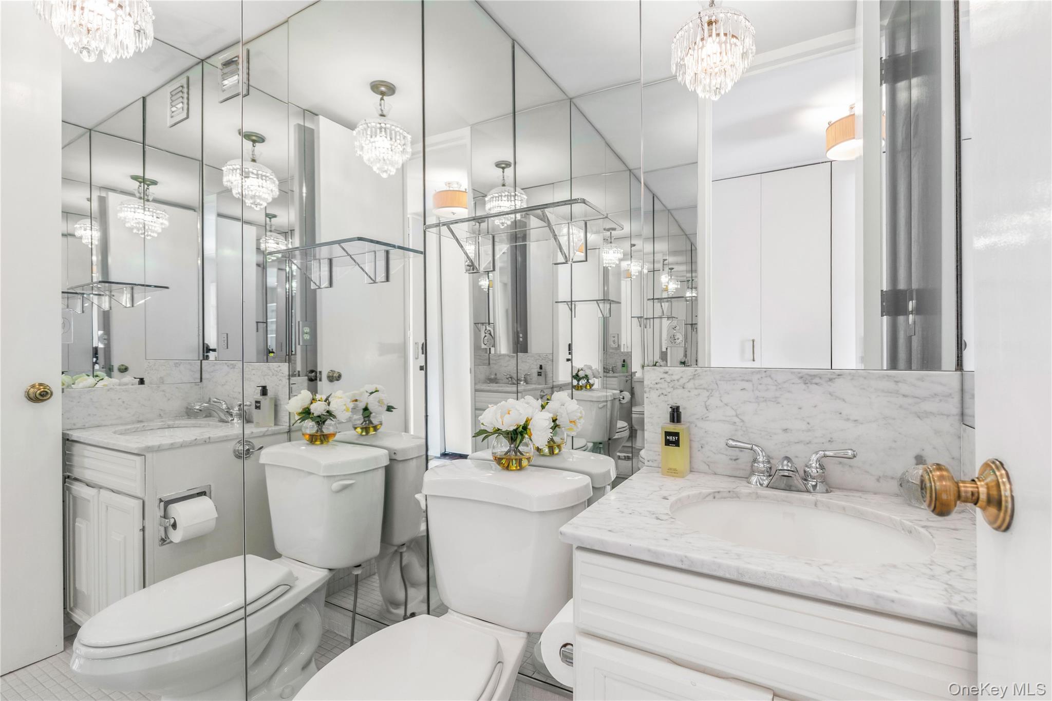 720 Milton Road, Unit SOUTH 3B Rye, NY 10580 - Photo 19 of 33 Powder room of light carrera marble counters and floor.