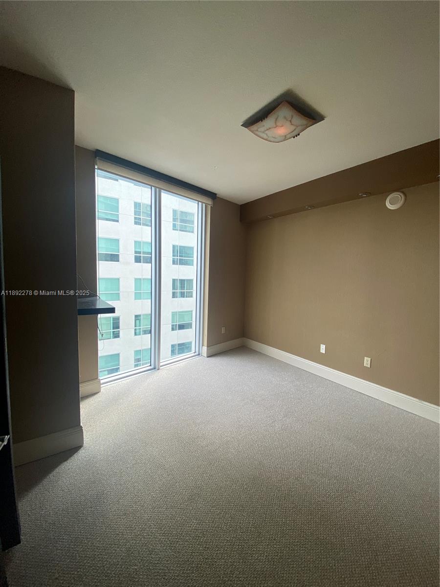 185 Southwest 7th Street, Unit 2312 Miami, FL 33130 - Photo 14 of 32 a view of an empty room with a window