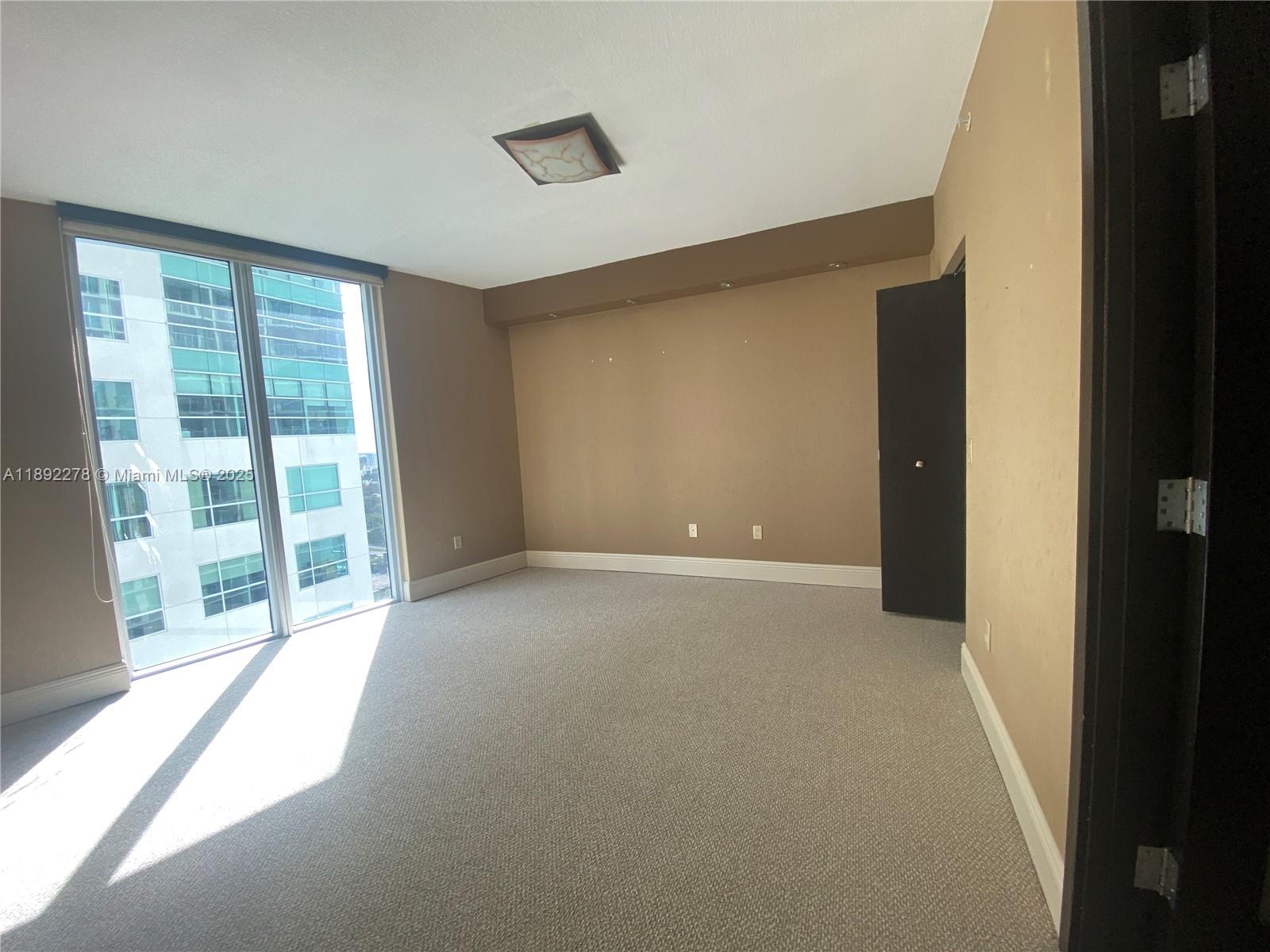 185 Southwest 7th Street, Unit 2312 Miami, FL 33130 - Photo 15 of 32 a view of an empty room with a window