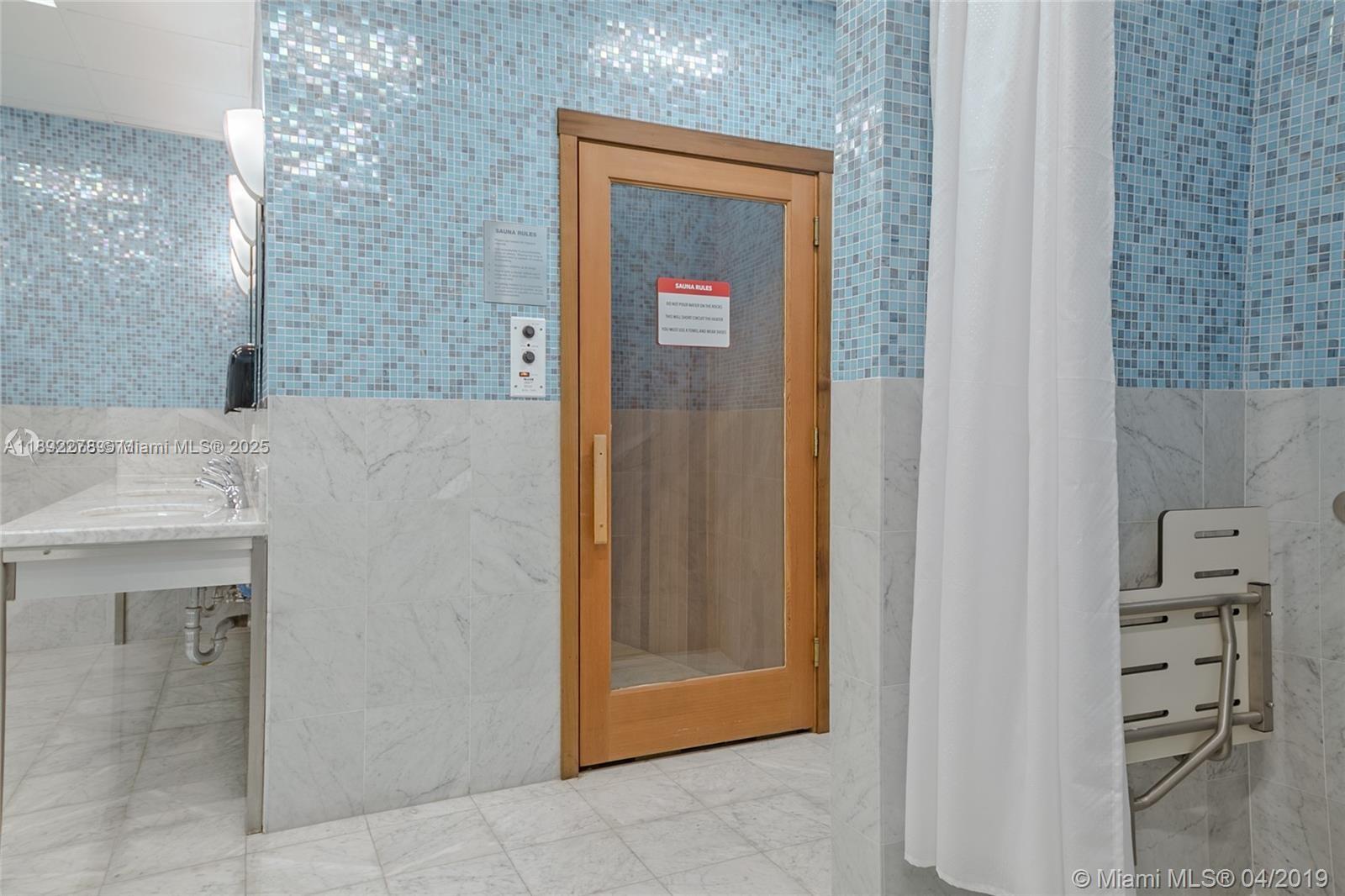 185 Southwest 7th Street, Unit 2312 Miami, FL 33130 - Photo 28 of 32 a bathroom with a bathtub and a sink