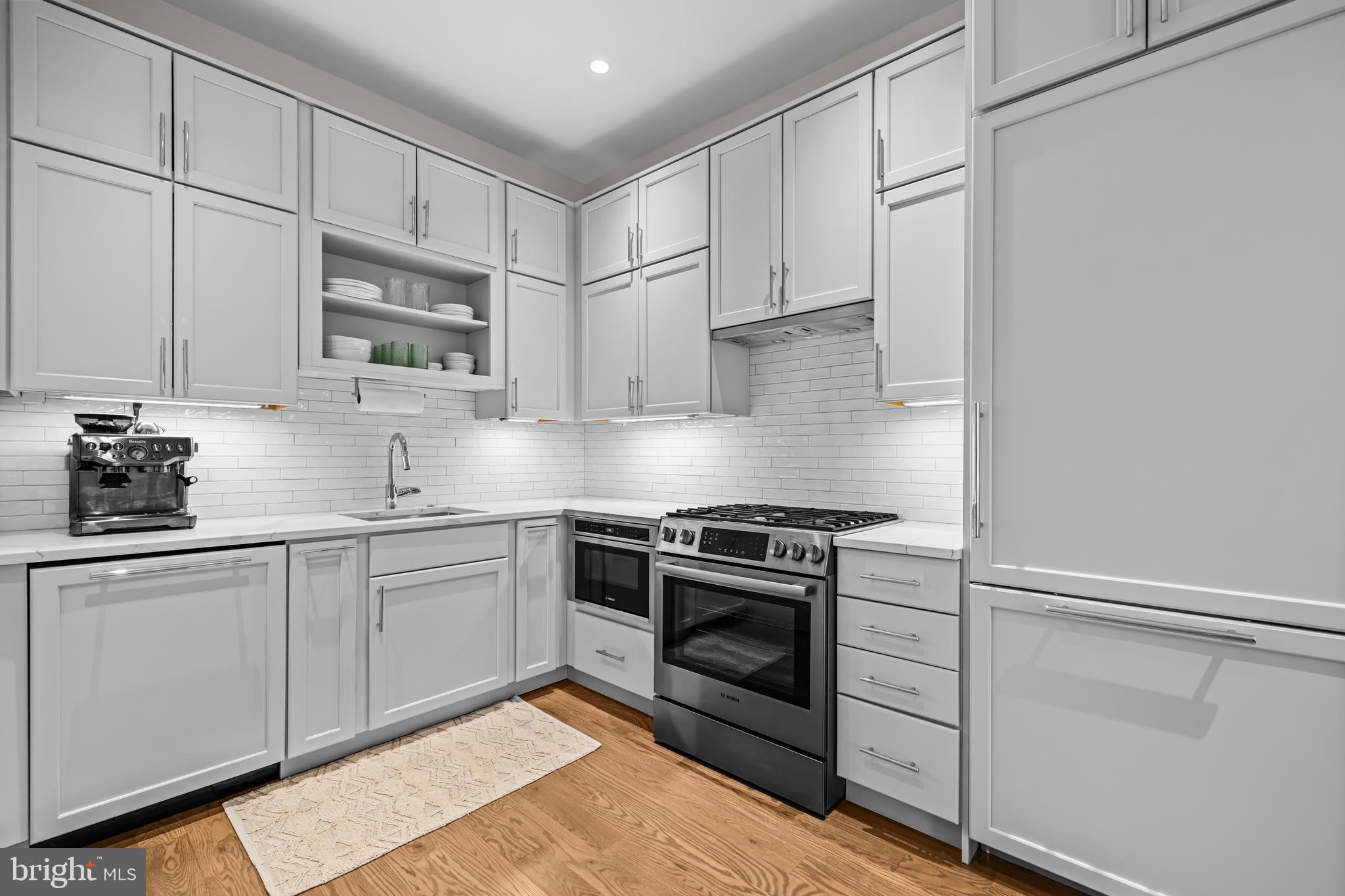 270 15th Street Southeast, Unit 301 Washington, DC 20003 - Photo 14 of 31 a kitchen with stainless steel appliances granite countertop a stove a sink and white cabinets
