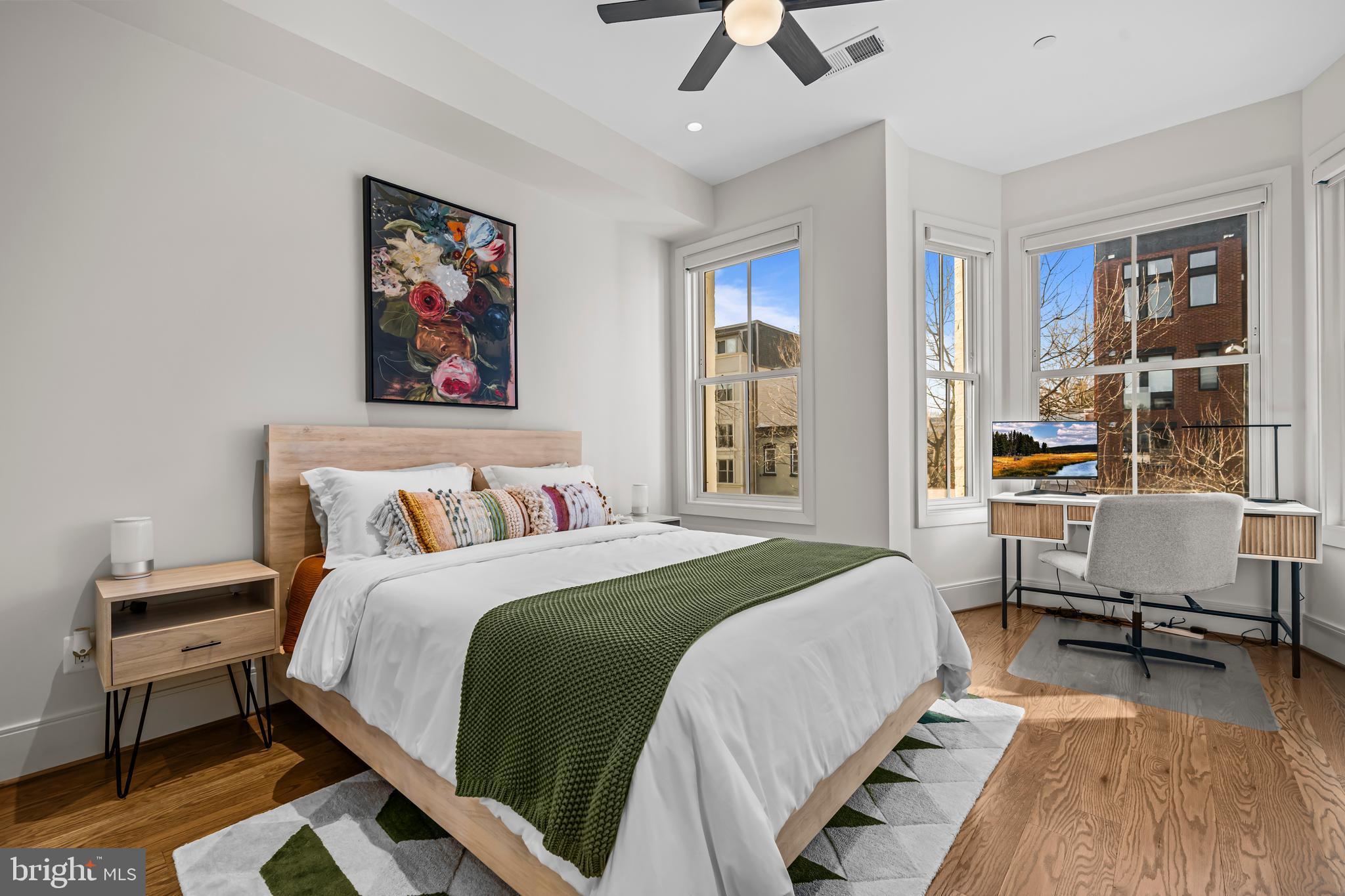 270 15th Street Southeast, Unit 301 Washington, DC 20003 - Photo 16 of 31 a bedroom with a bed wall painting and a window