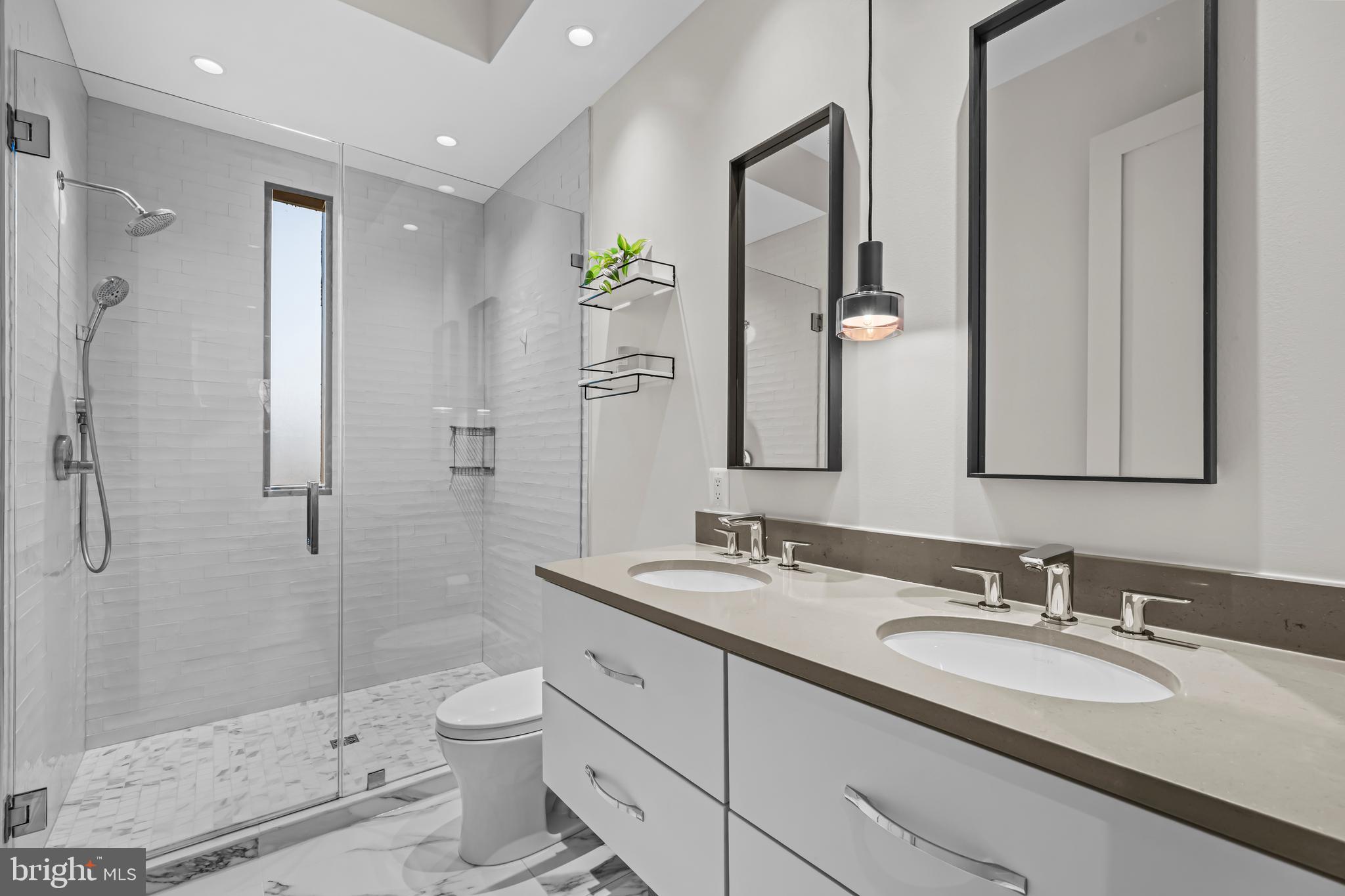270 15th Street Southeast, Unit 301 Washington, DC 20003 - Photo 20 of 31 a bathroom with a double vanity sink toilet and shower