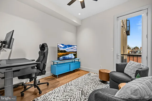 a livingroom with workspace and a couch