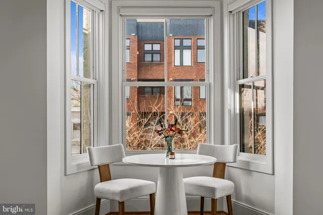 a view of a dining room with furniture and a window