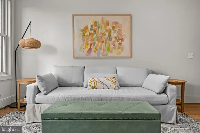 a living room with a couch and chandelier