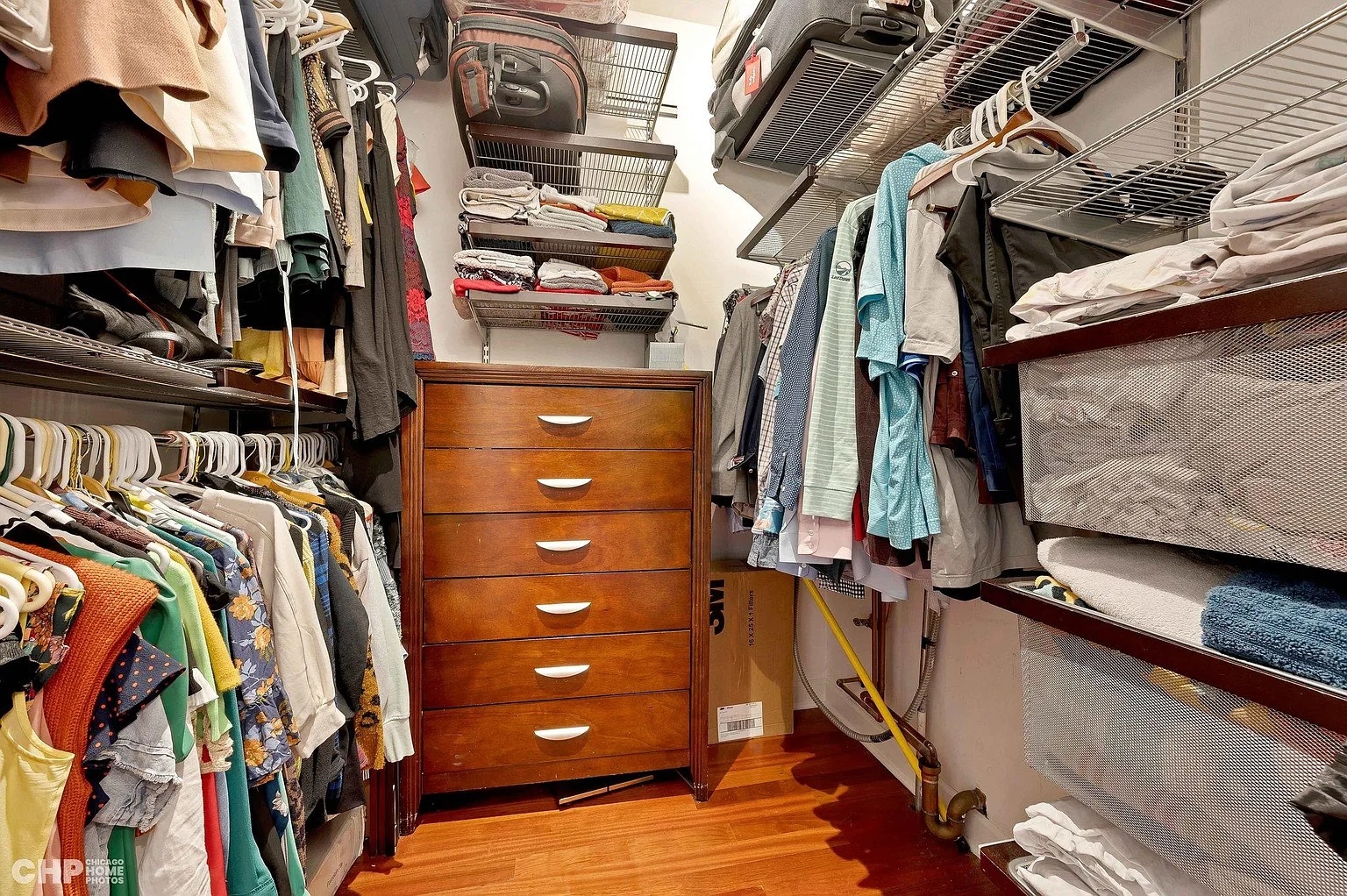 1035 West Madison Street, Unit 2 Chicago, IL 60607 - Photo 12 of 17 a view of walk in closet with clothes and shoes