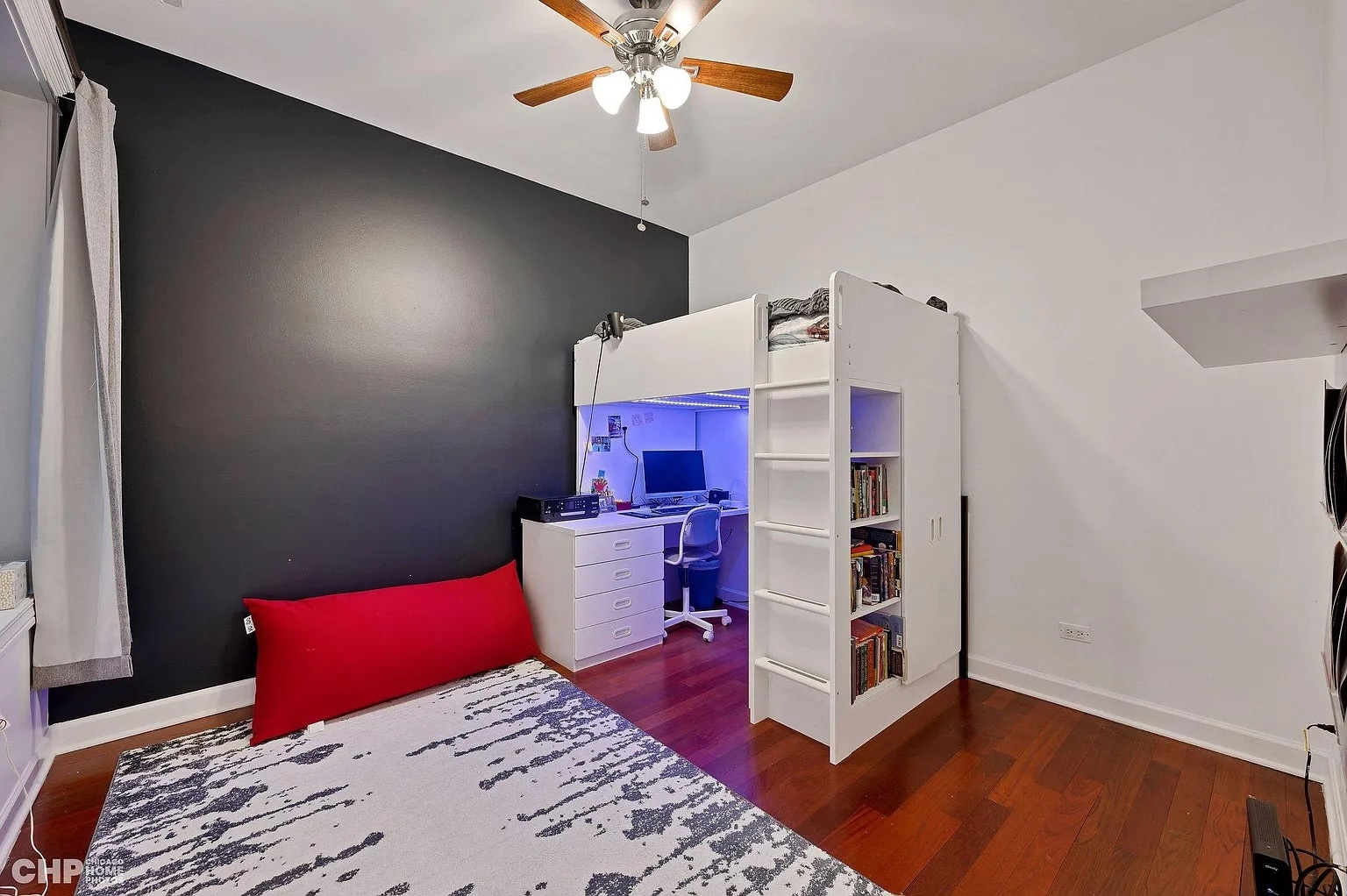 1035 West Madison Street, Unit 2 Chicago, IL 60607 - Photo 13 of 17 a bedroom with a bed and a chandelier