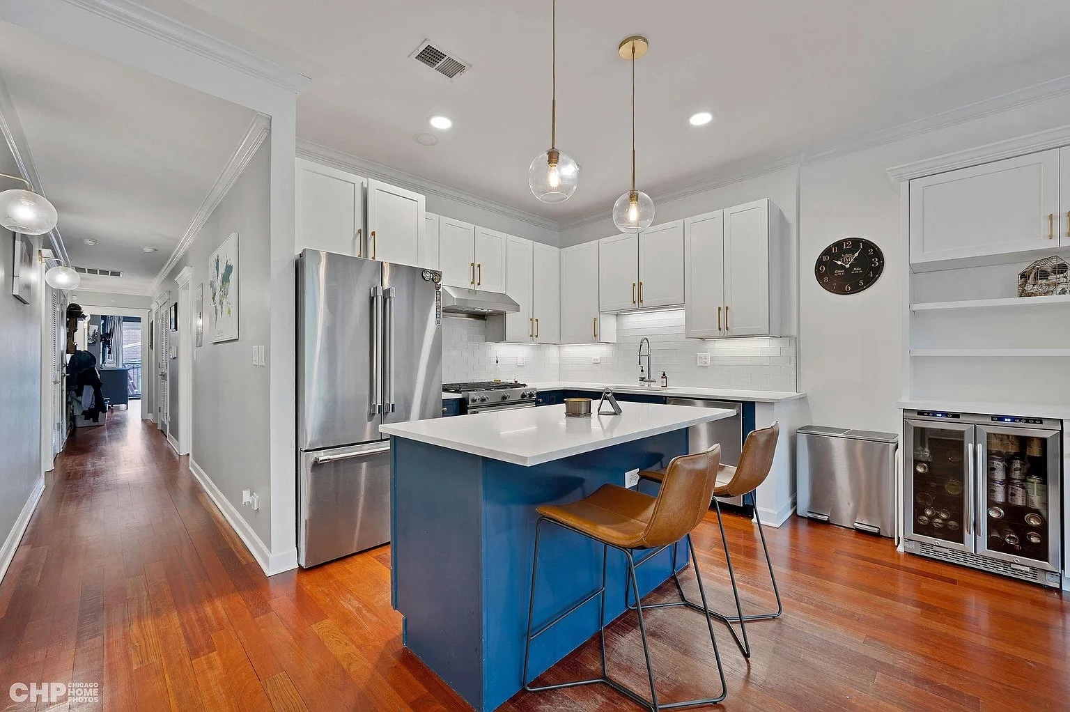 1035 West Madison Street, Unit 2 Chicago, IL 60607 - Photo 4 of 17 a kitchen with granite countertop a table chairs refrigerator and microwave